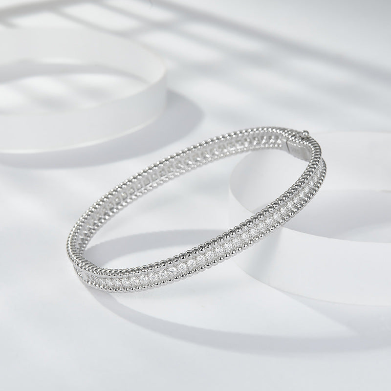 The same versatile stacked bracelet with full moissanite beads, beaded edge narrow bracelet is 925 silver plated 18K gold hand hoop.