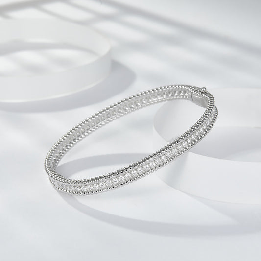 The same versatile stacked bracelet with full moissanite beads, beaded edge narrow bracelet is 925 silver plated 18K gold hand hoop.